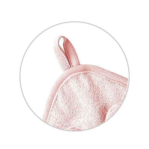 Pink hooded towel corner with bunny ear close-up, terry fabric texture