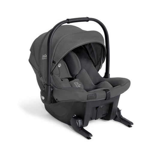 Infant car seat with hood, dark interior and visible safety harness straps