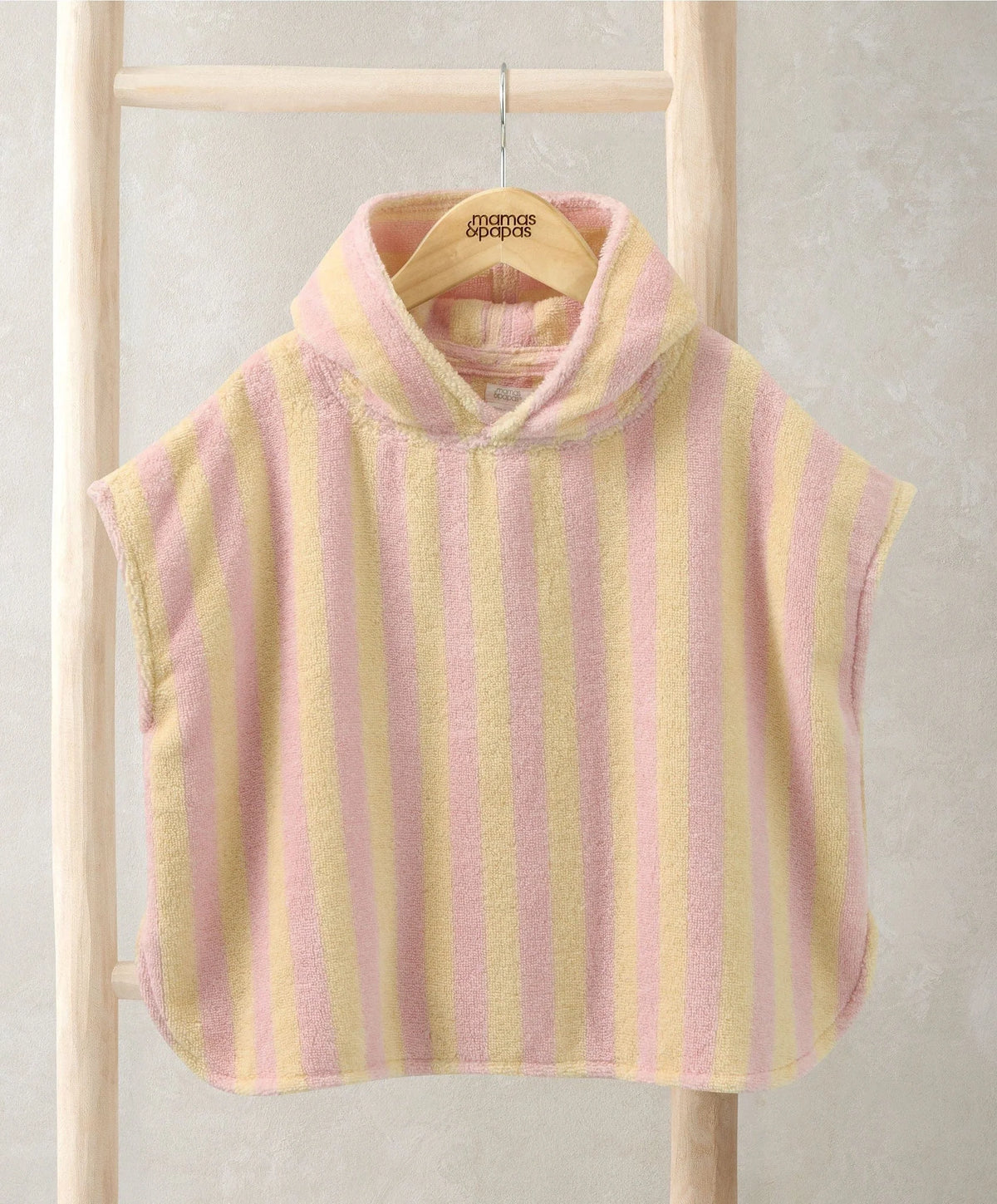 Pink striped poncho towel with rounded neck opening and soft terry-like texture
