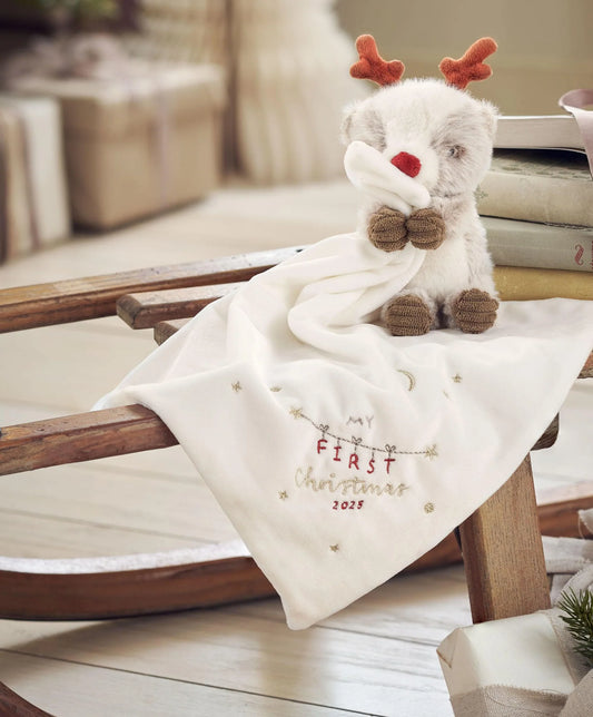 Cream reindeer comforter with plush reindeer head and red nose, embroidered 'First Christmas 2025'