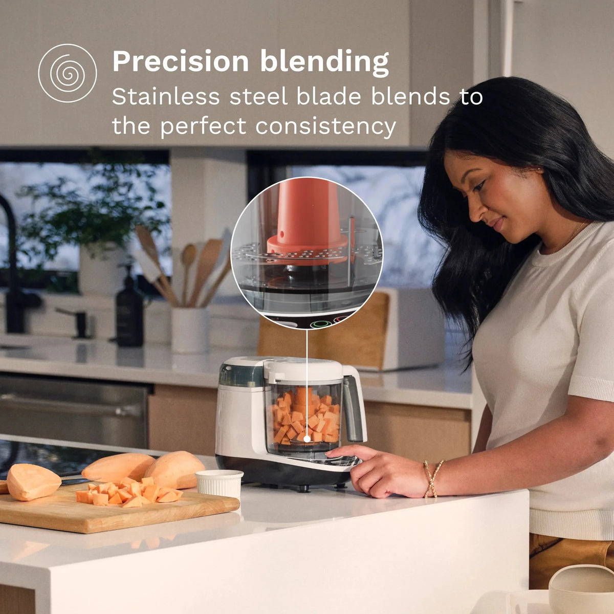 Baby food maker with stainless steel blade and woman using it