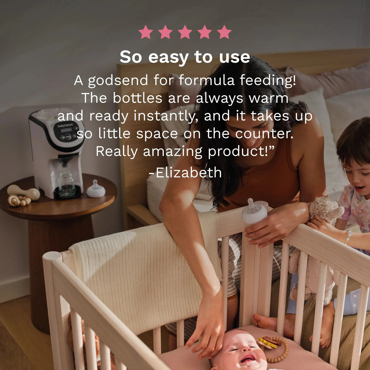 White babybrezza formula dispenser on bedside table near baby bottles