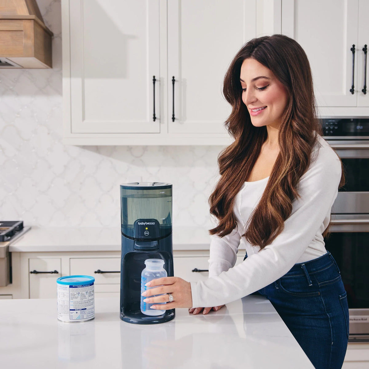 Instant warmer water dispenser dispensing a bottle on a kitchen countertop