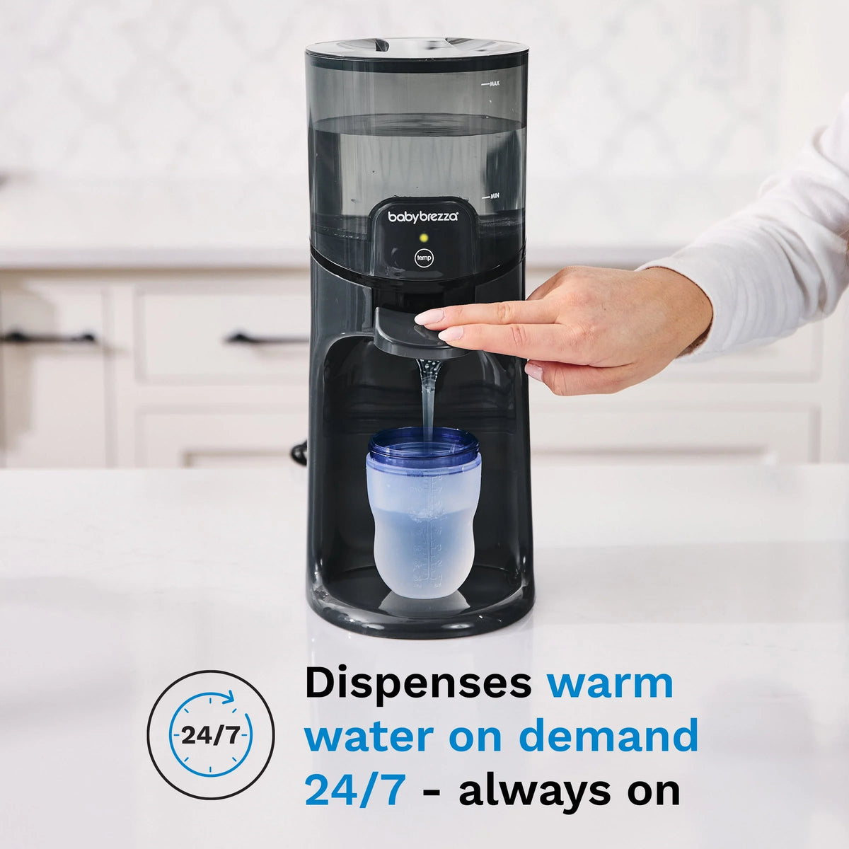 Black warm water dispenser with hand holding a bottle under the nozzle