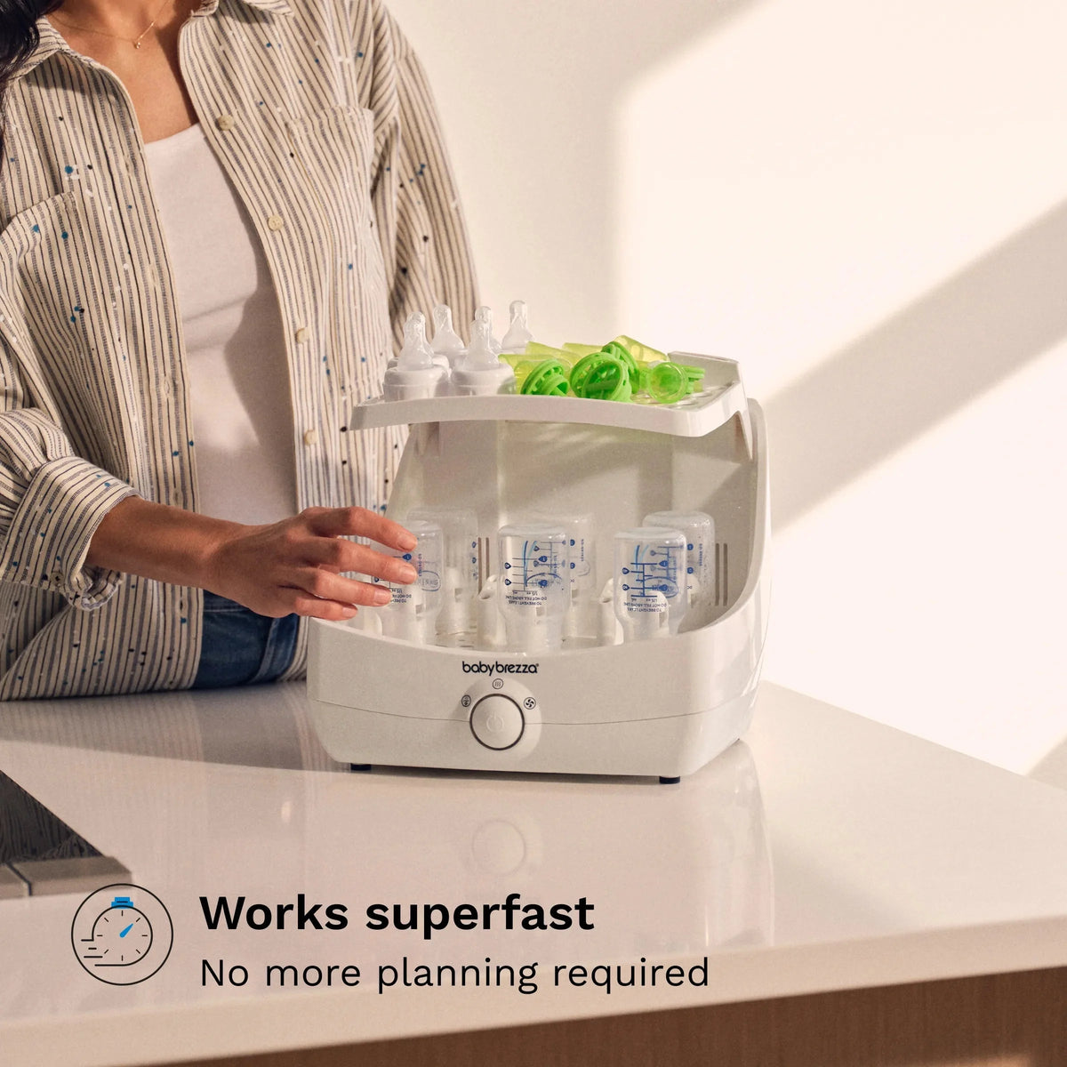 Sterilizer and dryer base with bottle rack and baby bottles inside