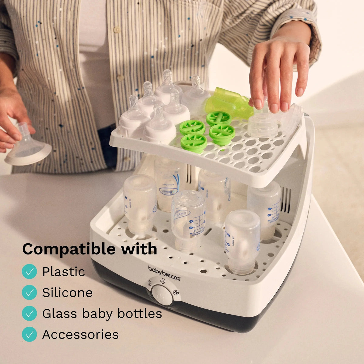 Sterilizer and dryer drying rack holding bottles, plastic rings, and accessories