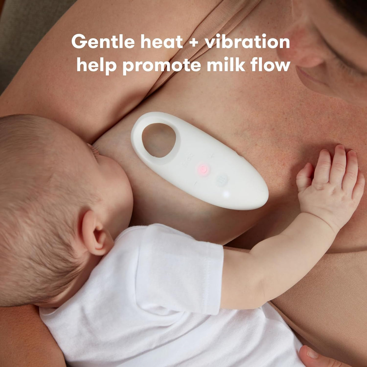 Lactation massager, white oval device with indicator light, held against skin