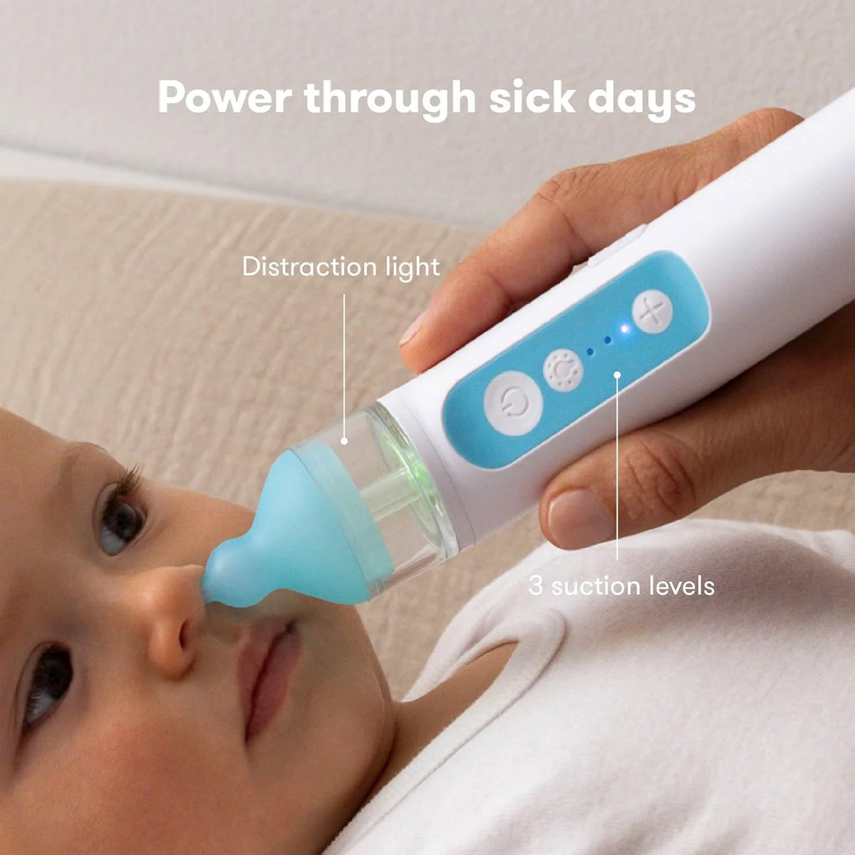 Baby using electric nasal aspirator with light blue tip and clear suction chamber