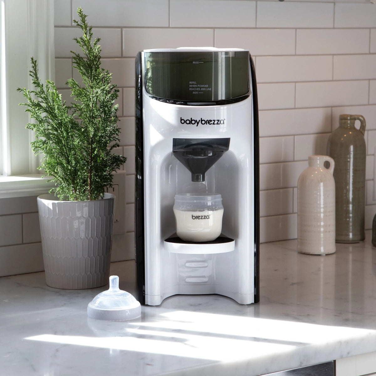 White countertop formula dispenser with stainless top and bottle dispensing spout