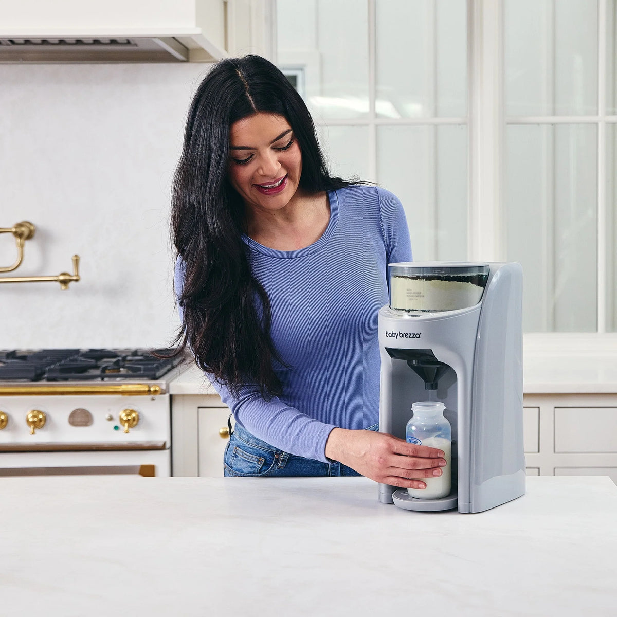 Black formula dispenser dispensing bottle on kitchen counter