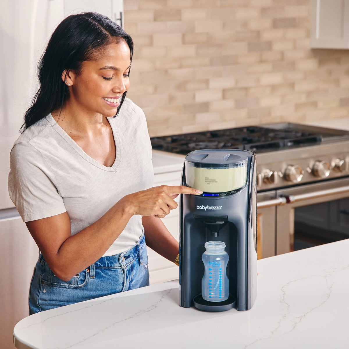 Black formula dispenser on countertop with bottle inside dispensing area