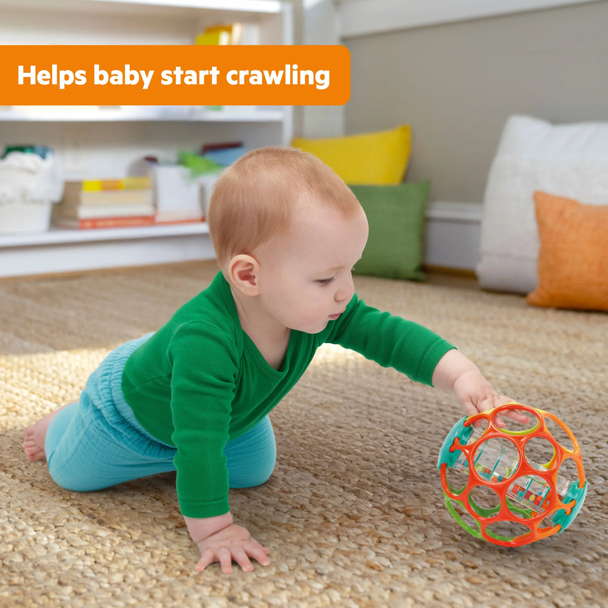 Colorful plastic rattle ball with multicolor rings, lying on carpet