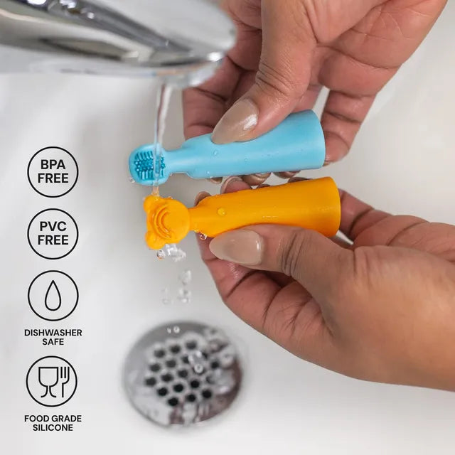 Silicone baby finger brush, blue and orange, held in hand for gum cleaning.
