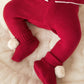 Red knit pom pom booties with ribbed cuff and fuzzy white pom-poms