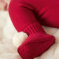 Red knit booties with cuff detail and small white pom-poms