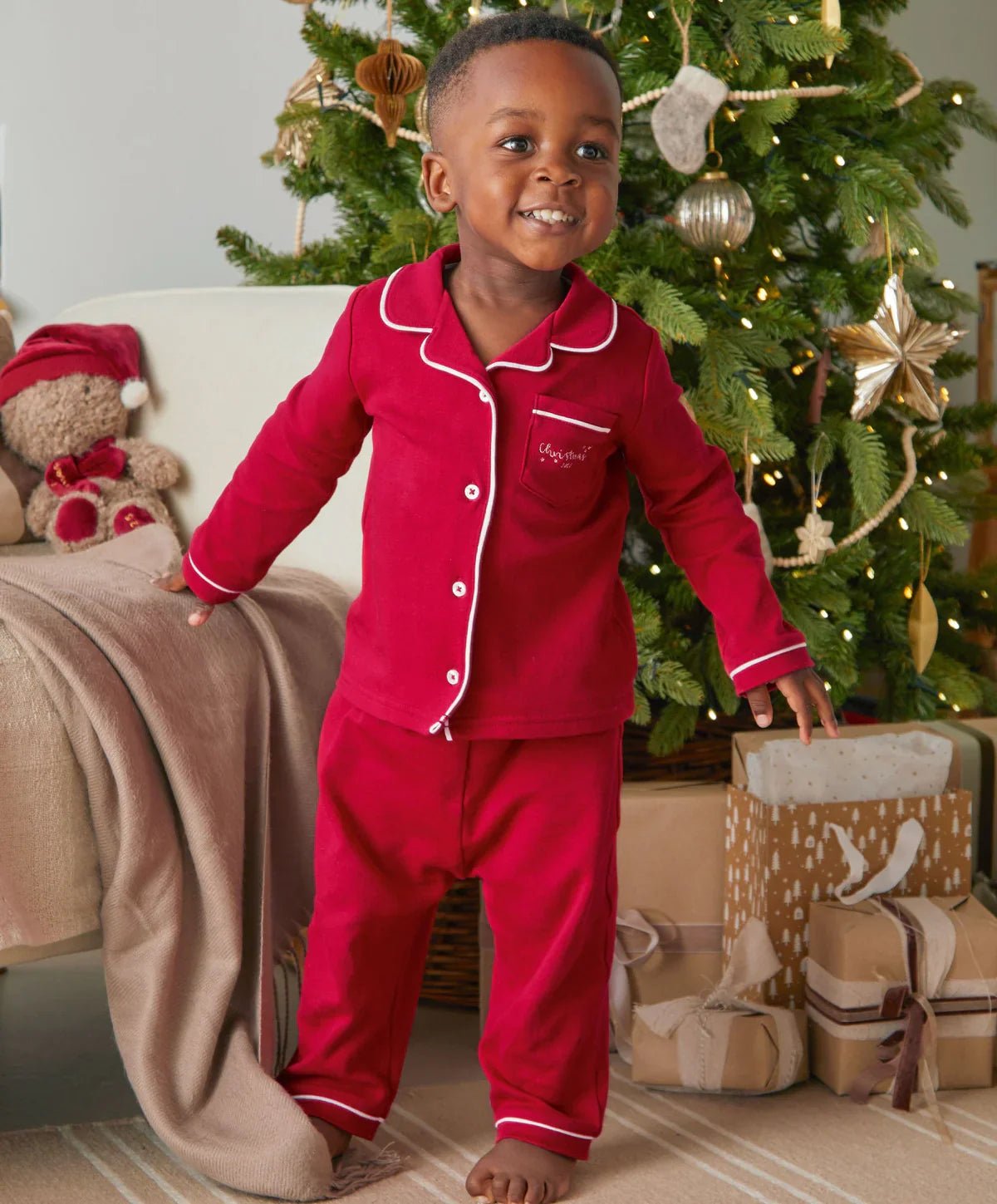 Red Christmas pyjama set with white piping, button-up top and cuffed pants