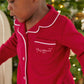 Red Christmas pyjama top with white-trim collar, chest pocket, and button placket