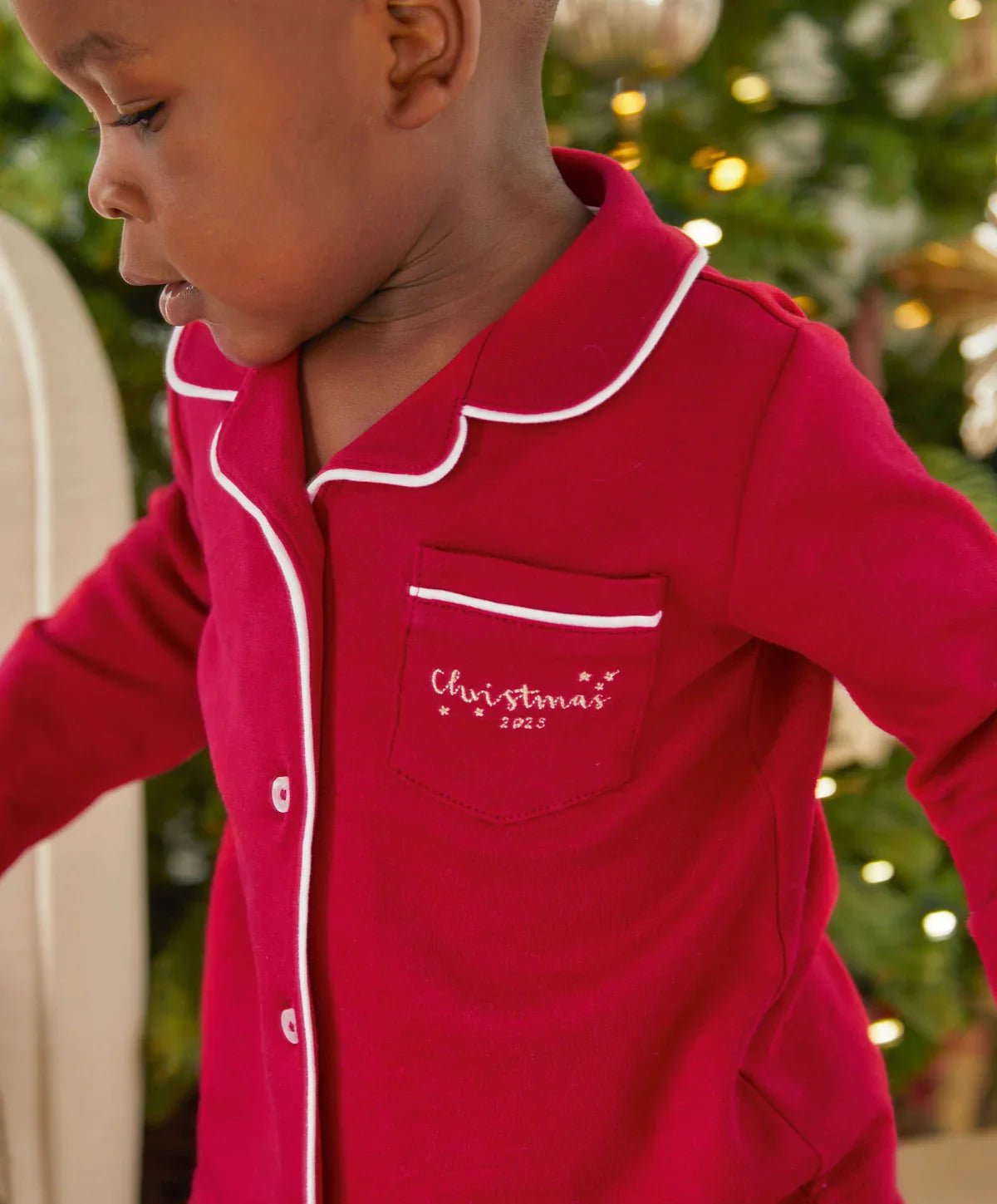Red Christmas pyjama top with white-trim collar, chest pocket, and button placket