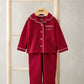 Red Christmas pyjama set with white-trim button front and matching pants