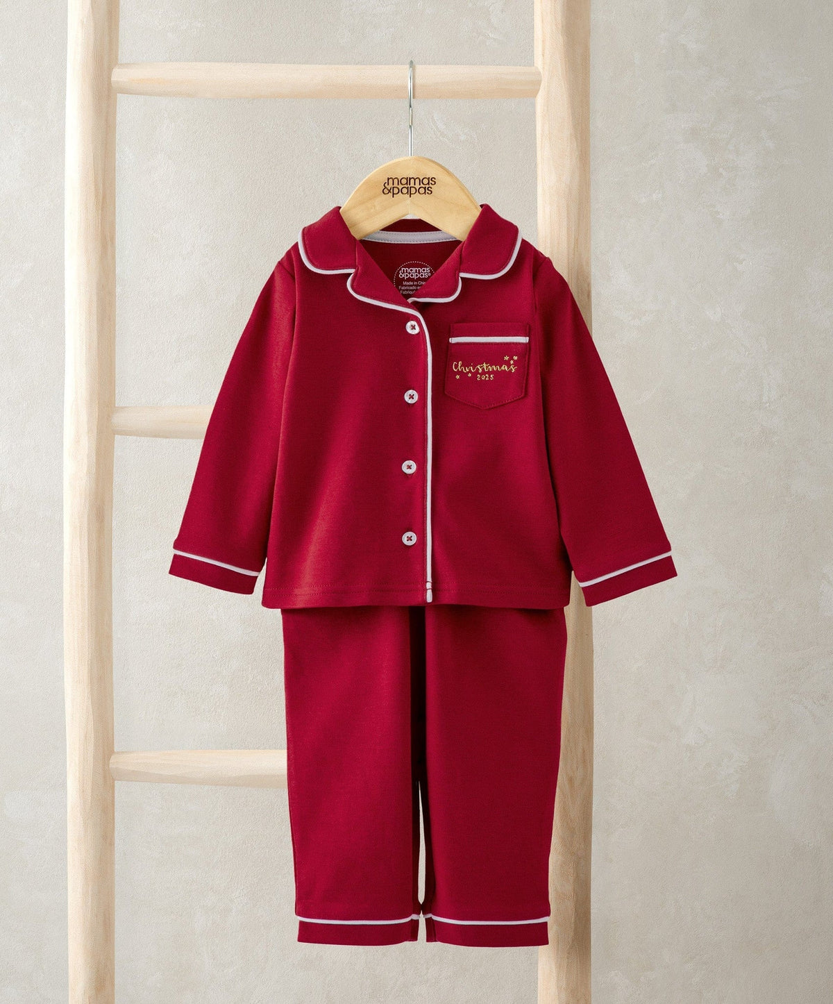 Red Christmas pyjama set with white-trim button front and matching pants