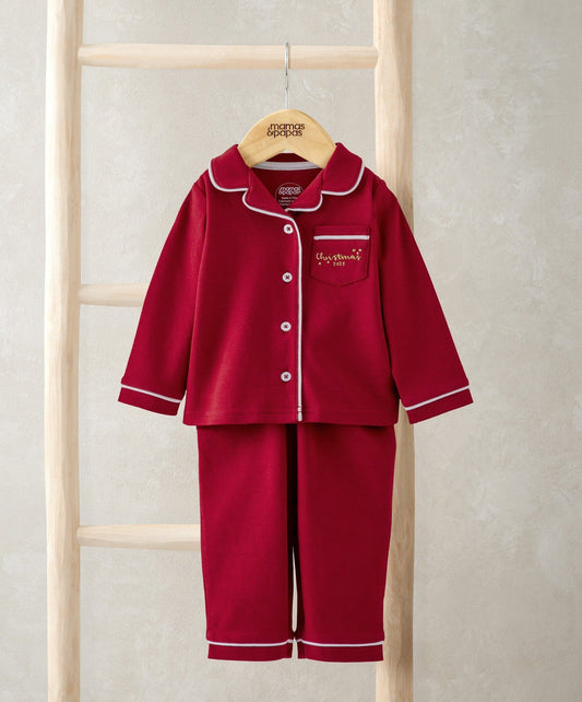 Red Christmas pyjama set with white-trim button front and matching pants