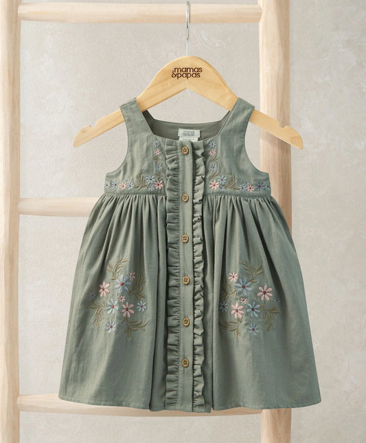 Floral pinafore dress in sage green with embroidered flowers and wooden button front.