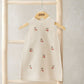 Cream knitted sleeveless dress with cherry embroidery and ribbed round neckline