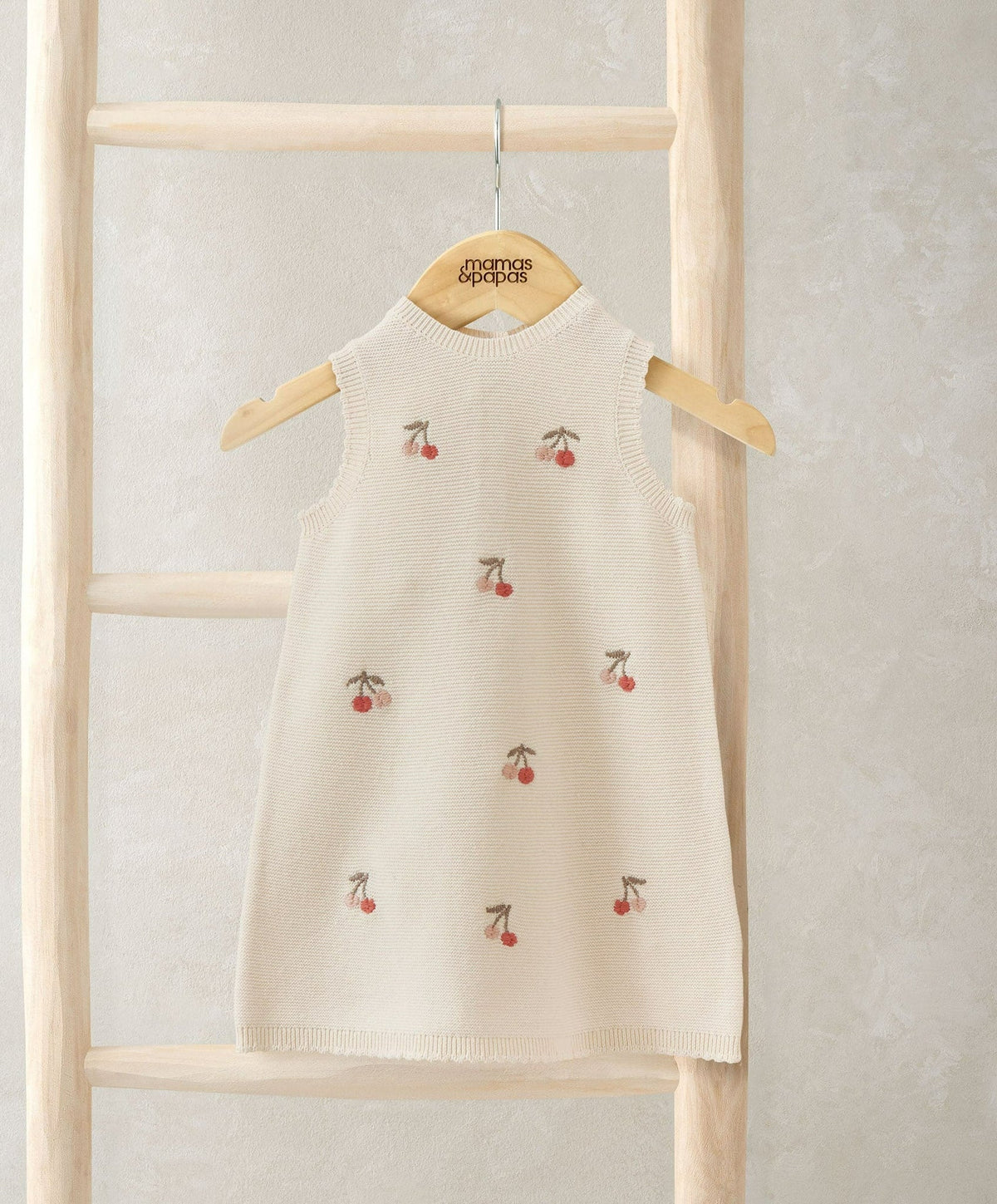 Cream knitted sleeveless dress with cherry embroidery and ribbed round neckline