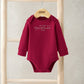 Red long-sleeve baby bodysuit with 'My first Christmas 2025' front print
