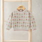 Floral knitted jumper with tulip print, cream knit, scalloped collar and red trim