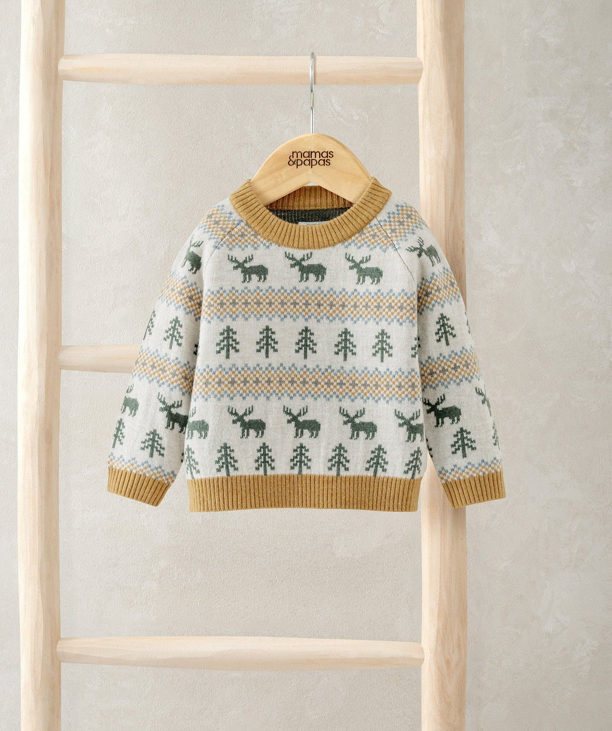 Cream knitted jumper with green moose and tree fair isle pattern, tan ribbed cuffs