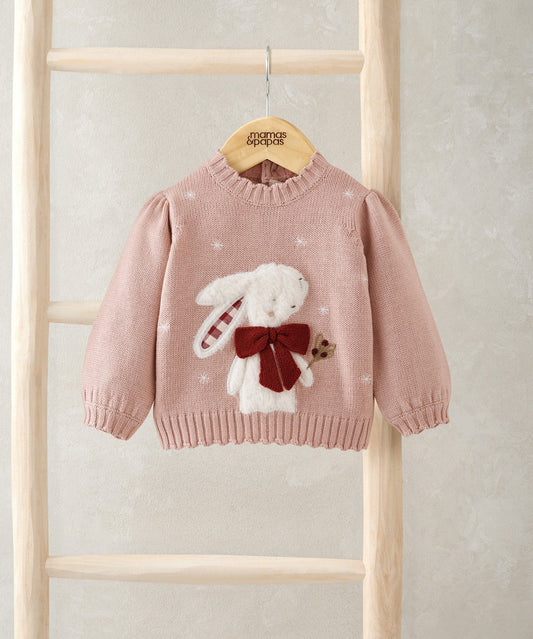 Light pink knit Christmas jumper with bunny appliqué and red bow at center, long sleeves