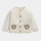 Kids cream knit cardigan with bear appliques and wooden-look button front.