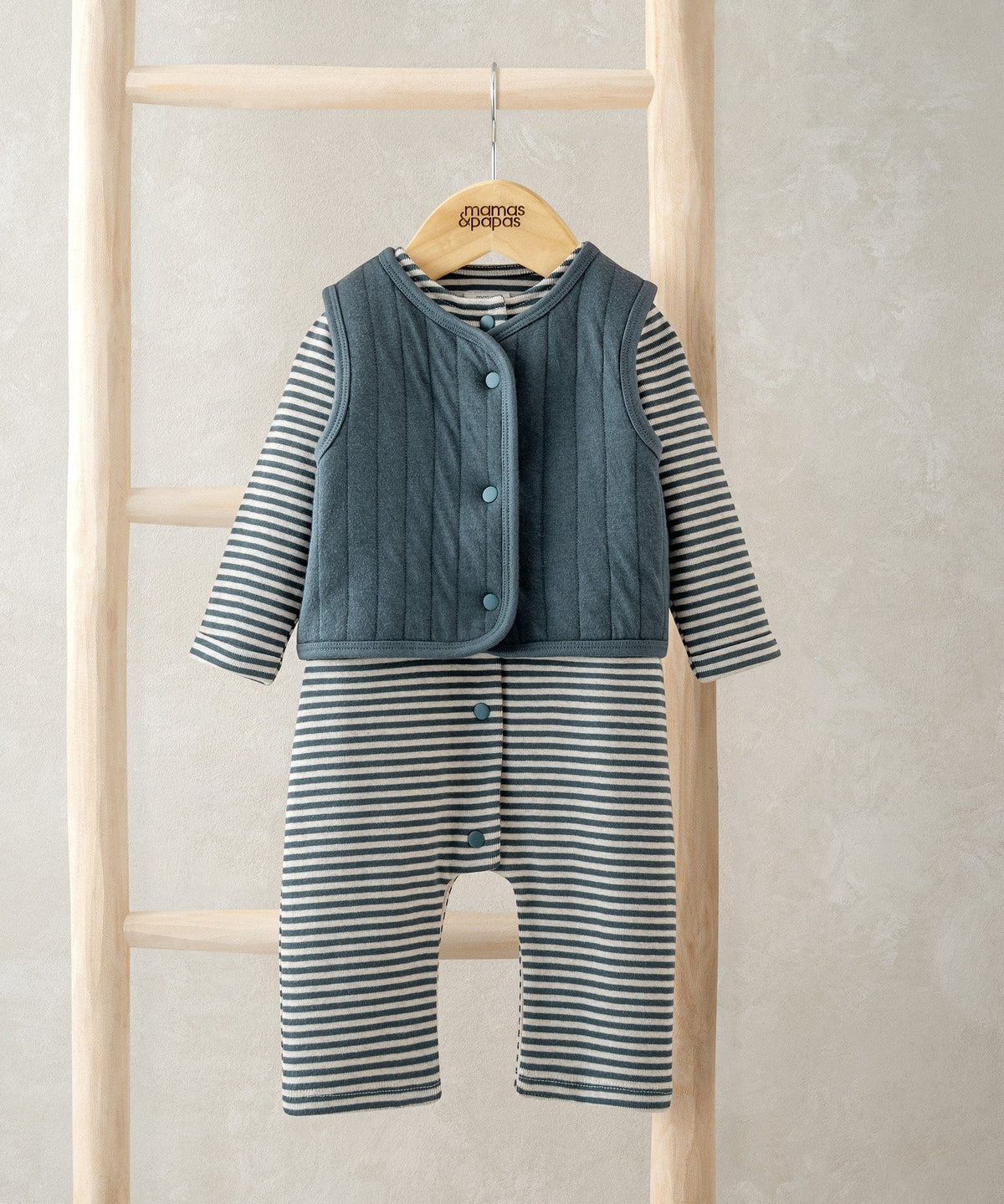 Striped romper with blue quilted vest and front snap closure