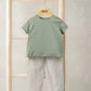 Outfit set on hanger: green-and-white striped tee and cream loose trousers