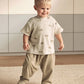 Ribbed t-shirt and trousers set on model, cream rhino print top with olive pants