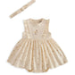 Cream mock skirt romper with ruffled sleeves and floral chest applique