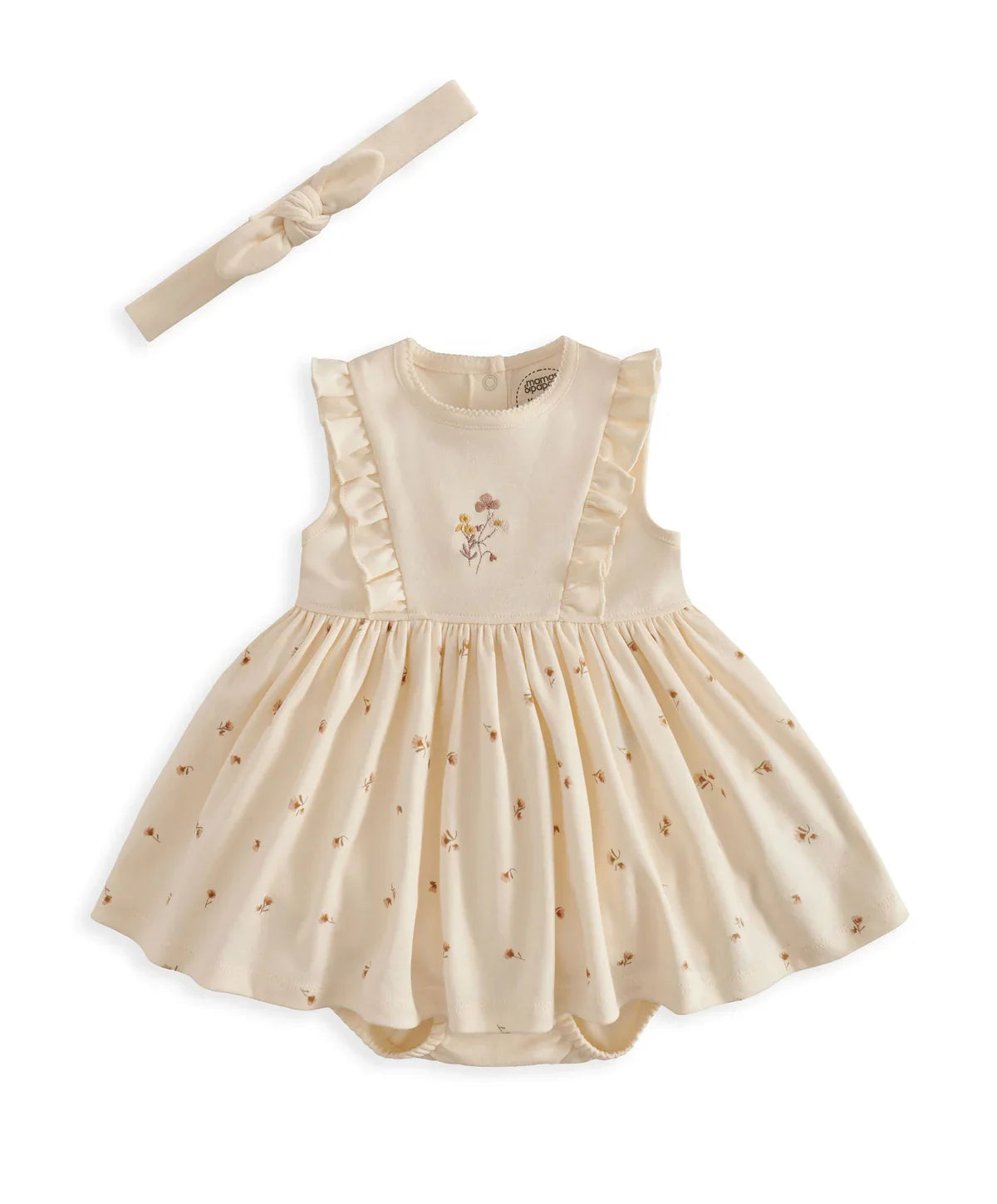 Cream mock skirt romper with ruffled sleeves and floral chest applique