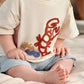 Cream t-shirt with red lobster and blue sea detail, paired with light blue shorts