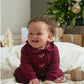 Burgundy soft knit romper on baby with long sleeves and front heart motifs