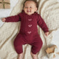 Burgundy soft knit romper with cable panel and heart embroidery long sleeves