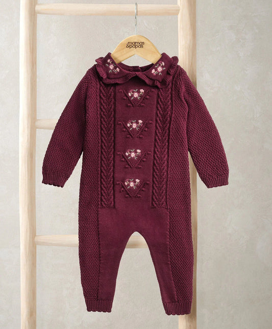 Burgundy soft knit romper with cable-knit long sleeves and footed legs