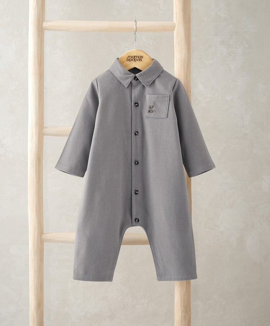 Grey woven button-up romper with collared neckline, chest pocket, long sleeves