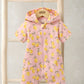 Hooded towel romper with yellow lemon print, full-zip front and side pockets, pink