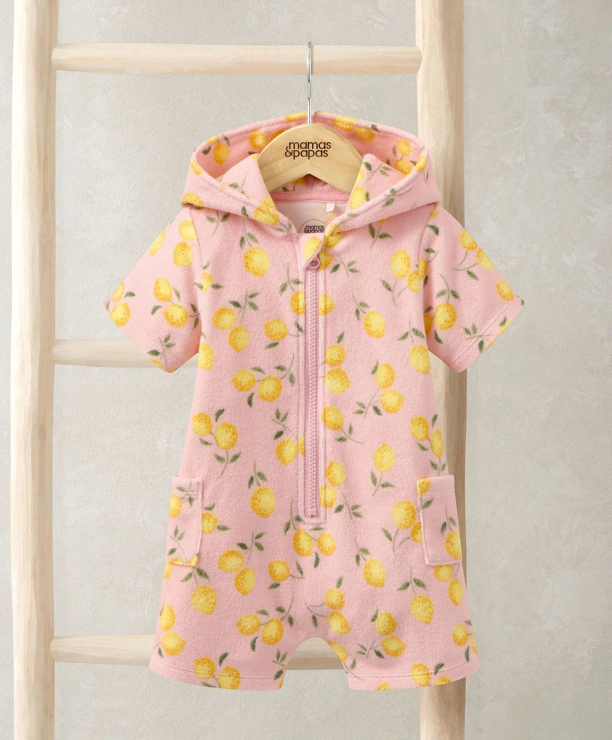 Hooded towel romper with yellow lemon print, full-zip front and side pockets, pink