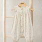 Cream frill-shoulder romper with tiny floral print, button front, gathered cuffs