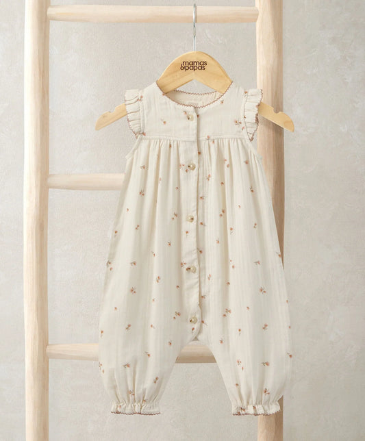 Cream frill-shoulder romper with tiny floral print, button front, gathered cuffs
