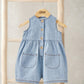 Light blue sleeveless chambray romper with button front and two front pockets