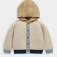 Color-block knit cardigan with hood, button placket, cream body, light blue stripe, navy hem