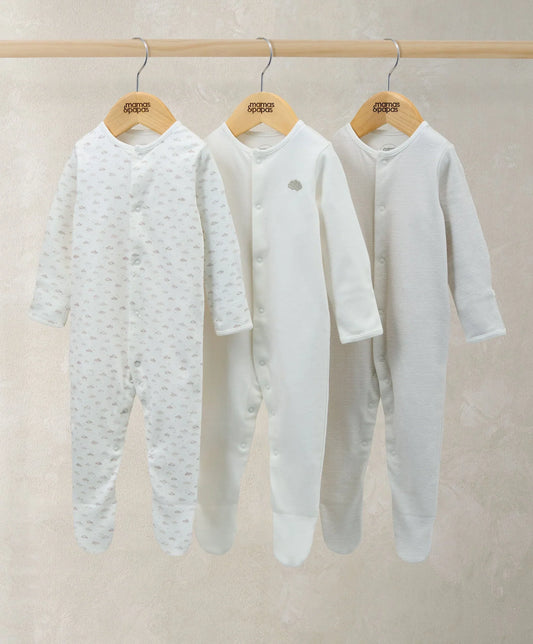 Pack of 3 white sleepsuits with button front; two feature small all-over prints